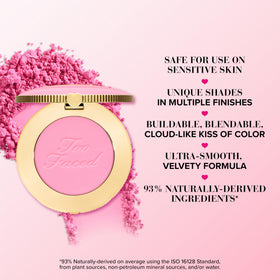 Too Faced swatch on arm displaying buildable pigment and natural warm coral payoff