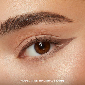 Too Faced metallic burgundy swatch on skin showing color payoff and sheen