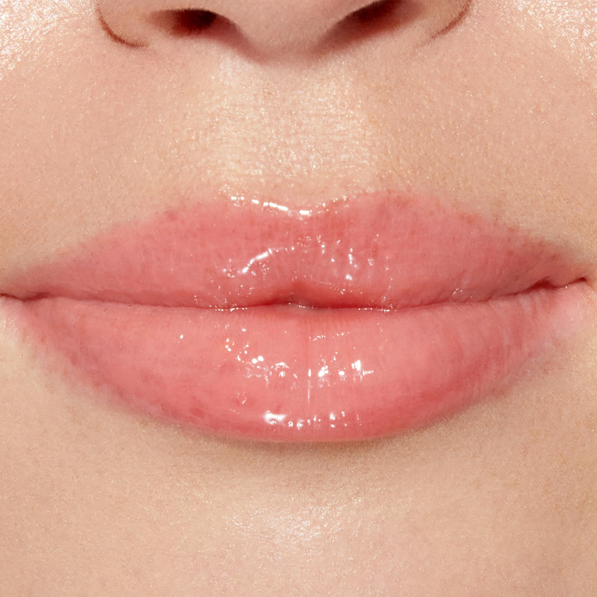 Too Faced gloss applied on lips closeup showing plumped, hydrated appearance