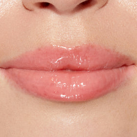 Too Faced gloss applied on lips closeup showing plumped, hydrated appearance