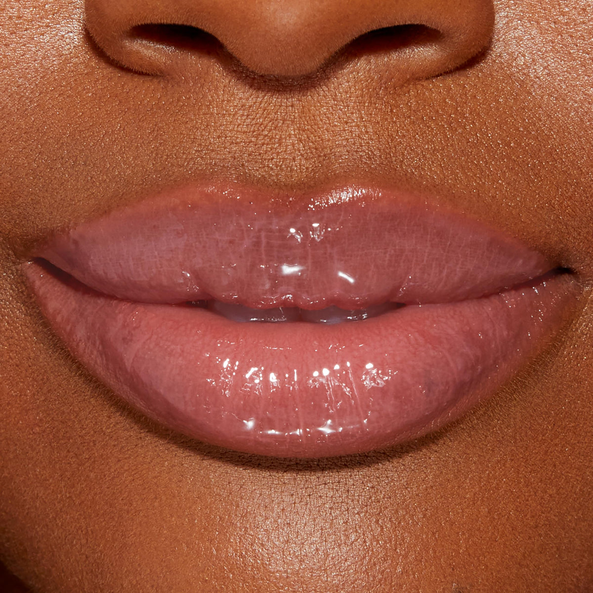 Too Faced model applying gloss in lifestyle scene showing quick daily enhancement