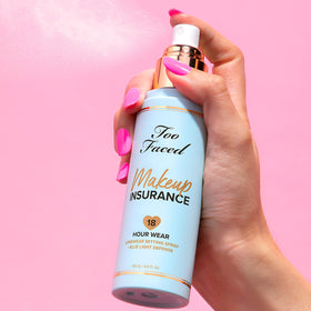 Close-up mist on skin demonstrating hydration from Too Faced spray for refreshed look