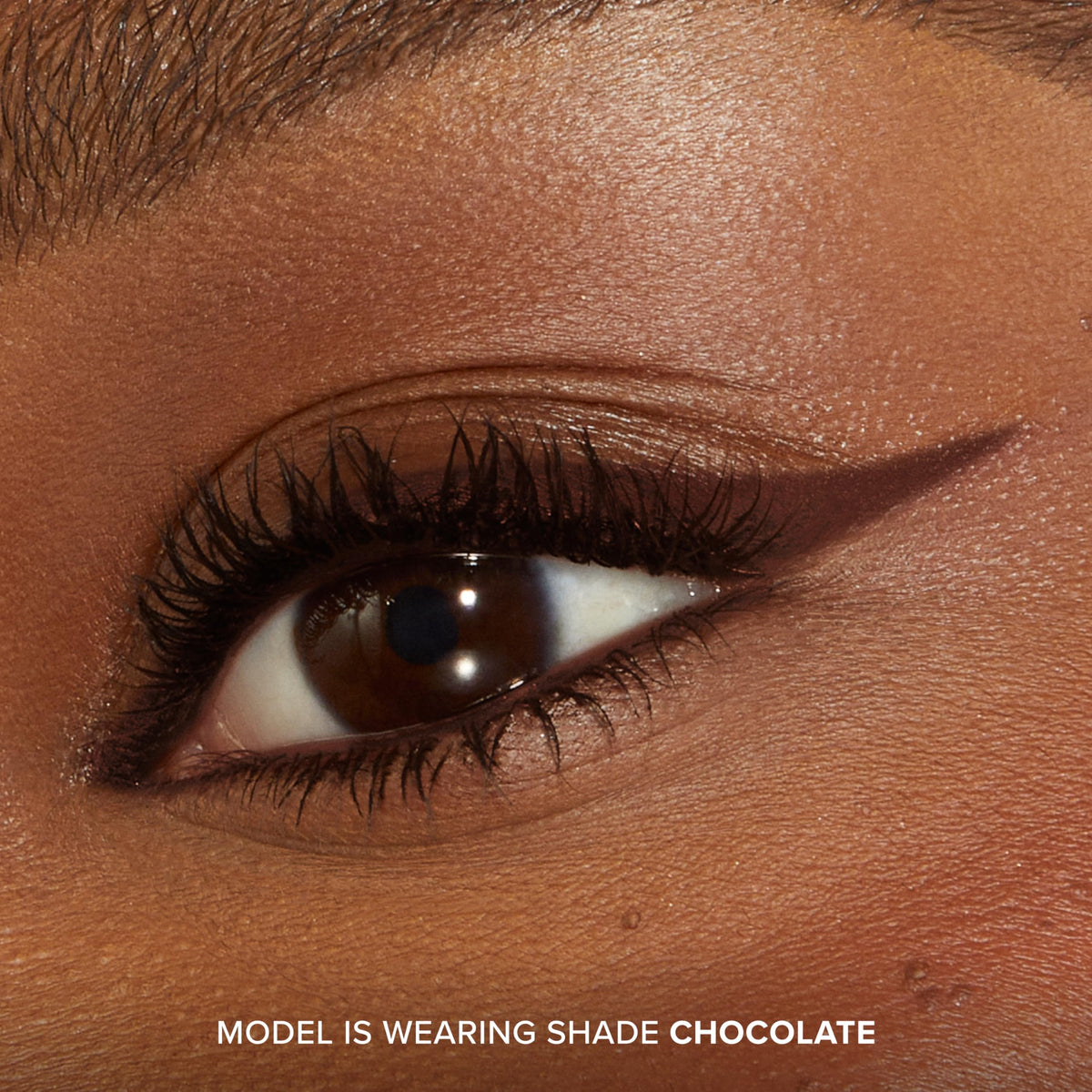 Too Faced pencil held in hand to show compact travel-friendly size