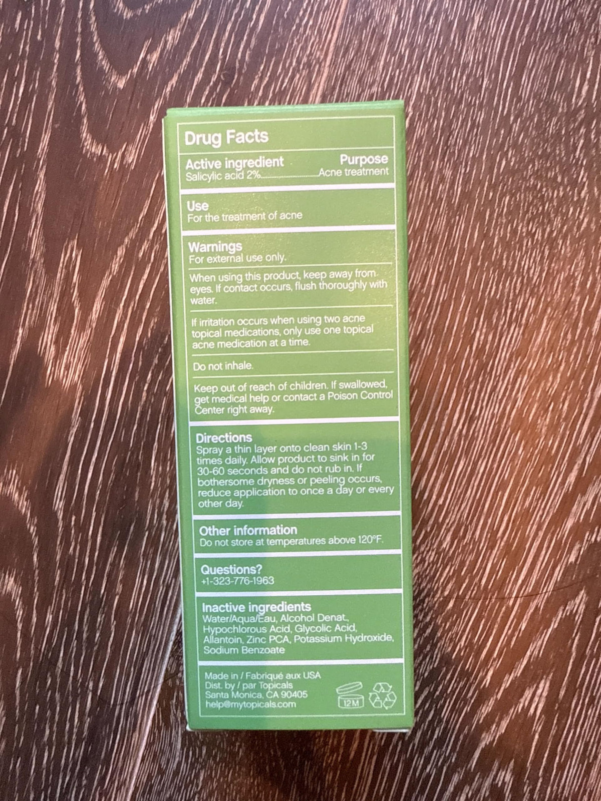 Topicals Clearly bottle held in hand for size comparison and travel convenience
