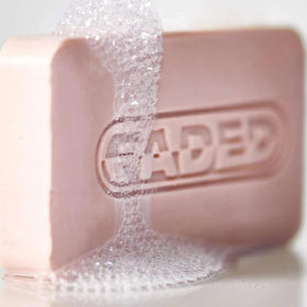 Topicals cleansing bar size comparison in hand showing compact travel-friendly convenience