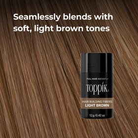 hand holding TOPPIK 27.5g bottle to show compact travel-friendly size