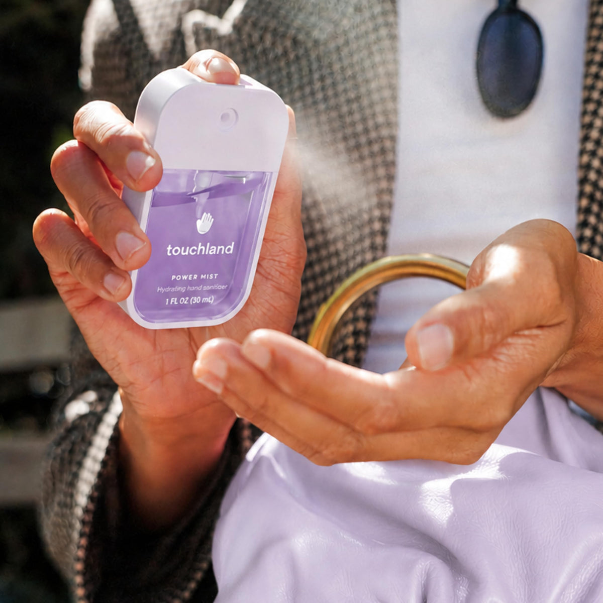Touchland bottles in travel kit flatlay for on-the-go sanitizing benefit