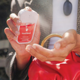 Touchland cap and spray detail illustrating secure closure and travel readiness