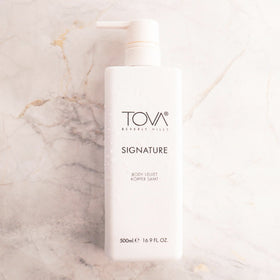 Tova lotion texture close-up highlighting silky shea butter finish and hydration