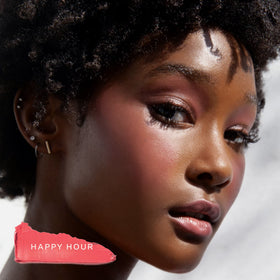 Tower 28 lip and cheek tint in a beach setting conveying sun-kissed glow