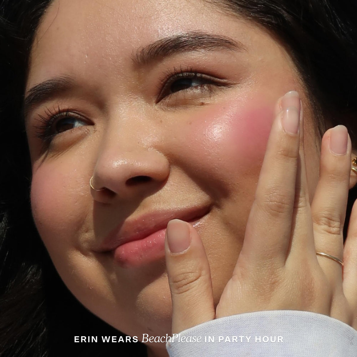 Model applying Tower 28 Party Hour to cheek for natural dewy color