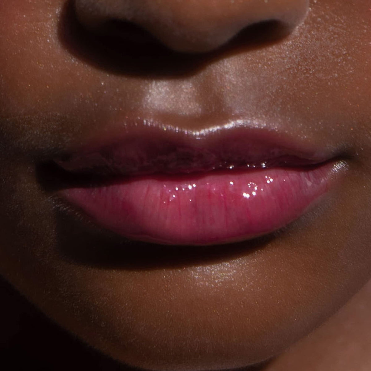 Tower 28 layered over lipstick as glossy topper showing added shine and dimension benefit