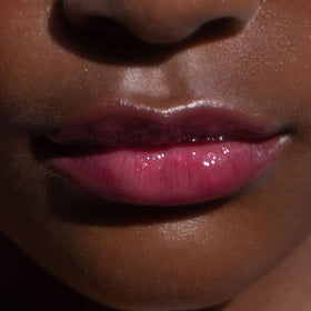 Tower 28 layered over lipstick as glossy topper showing added shine and dimension benefit