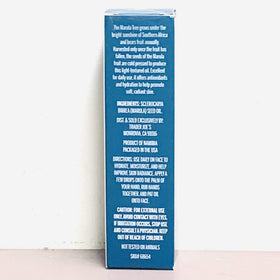 Trader Joe's marula oil pipette dispensing clear drops onto skin showing quick absorption and glow