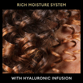 TRESemmé conditioner in shower being applied to hair demonstrating detangling benefit