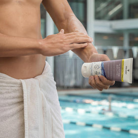 TRIHARD bottle in swim bag lifestyle scene emphasizing poolside protection benefit