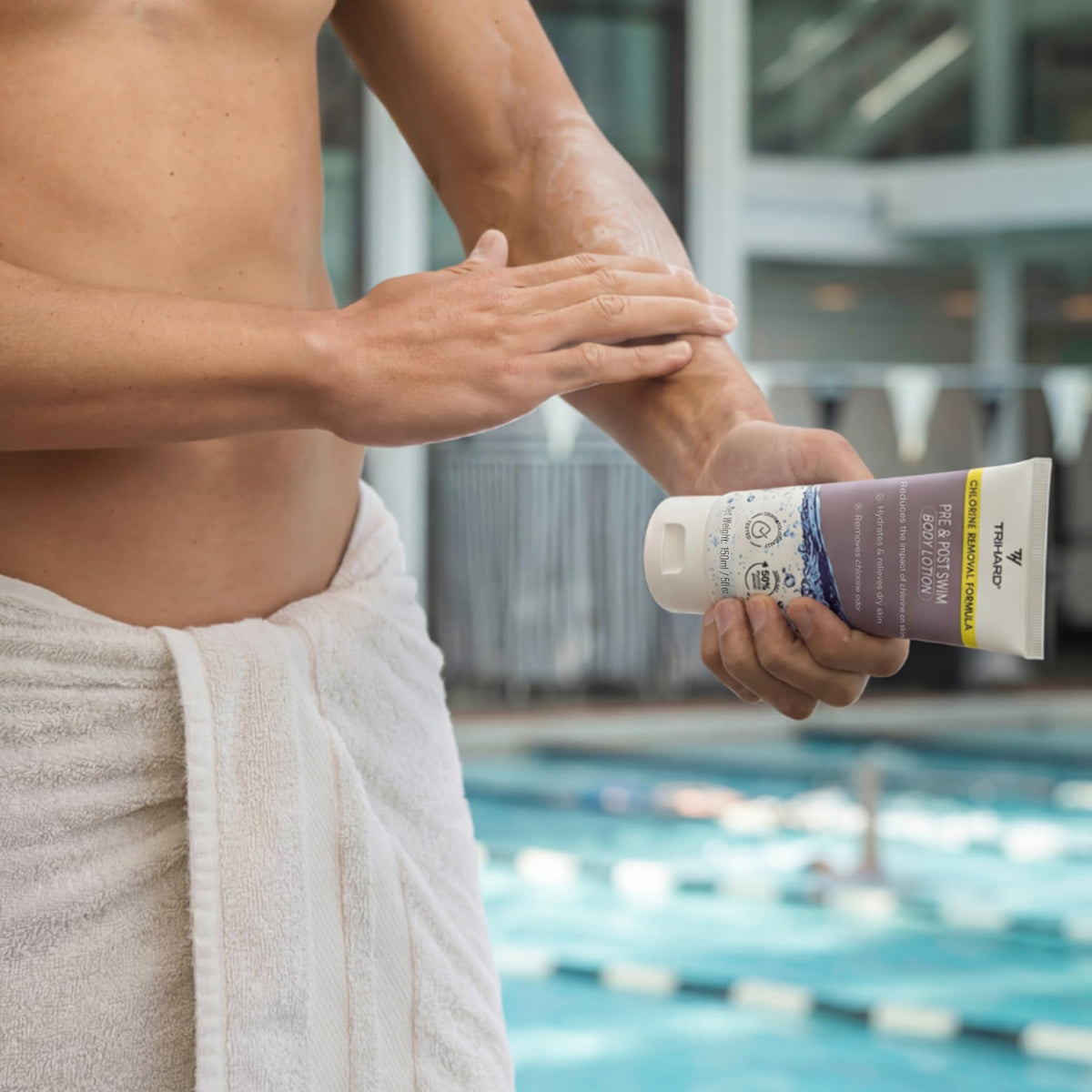 TRIHARD bottle beside swim goggles showing product size and travel-friendly benefit
