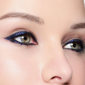 Trish McEvoy model applying gel liner at lash line, shows precision and control