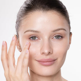 Trish McEvoy product being gently patted around eye to show application and smoothing benefit