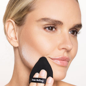 Trish McEvoy compact in a travel bag showing convenience for on-the-go touch-ups benefit