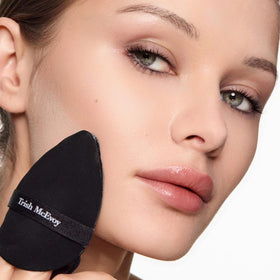 Trish McEvoy refill beside coin showing compact size and portability benefit