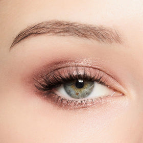 Trish McEvoy model applying stick to eyelid for quick, crease-resistant finish