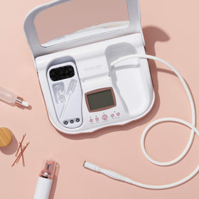 Trophy Skin MicrodermMD staged on bathroom counter with skincare products for at-home spa feel