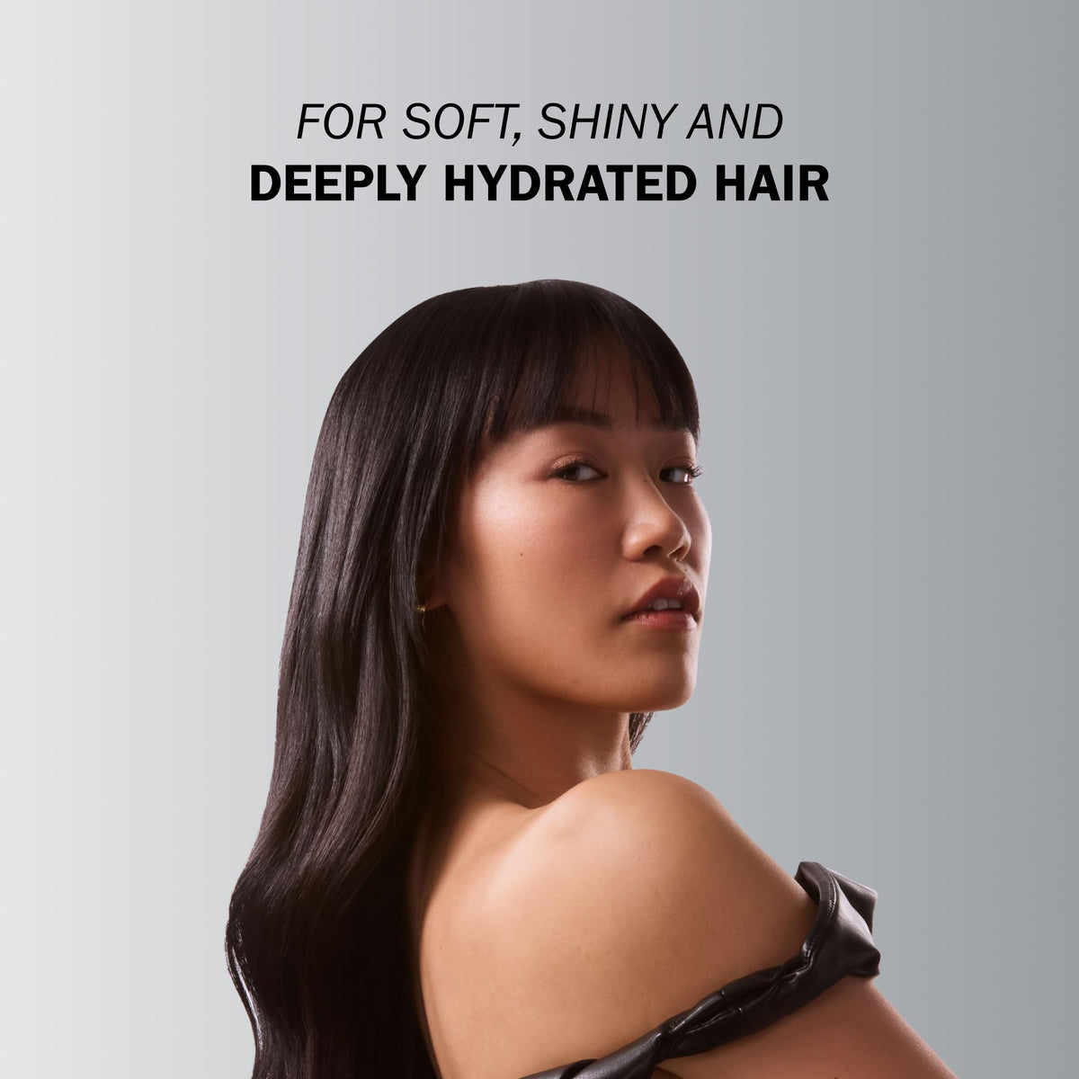 TRUSS applying mask to hair mid-lengths demonstrating detangling benefit