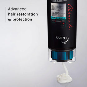 Hand holding TRUSS Miracle Conditioner ready to apply, demonstrating simple at-home use
