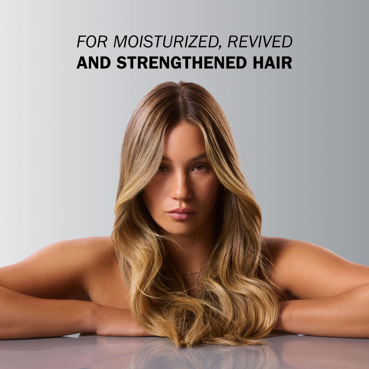 TRUSS applying Miracle Summer Mask to wet mid-lengths to restore damaged hair