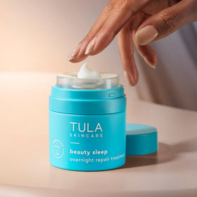 TULA jar open with creamy texture visible to show moisturization