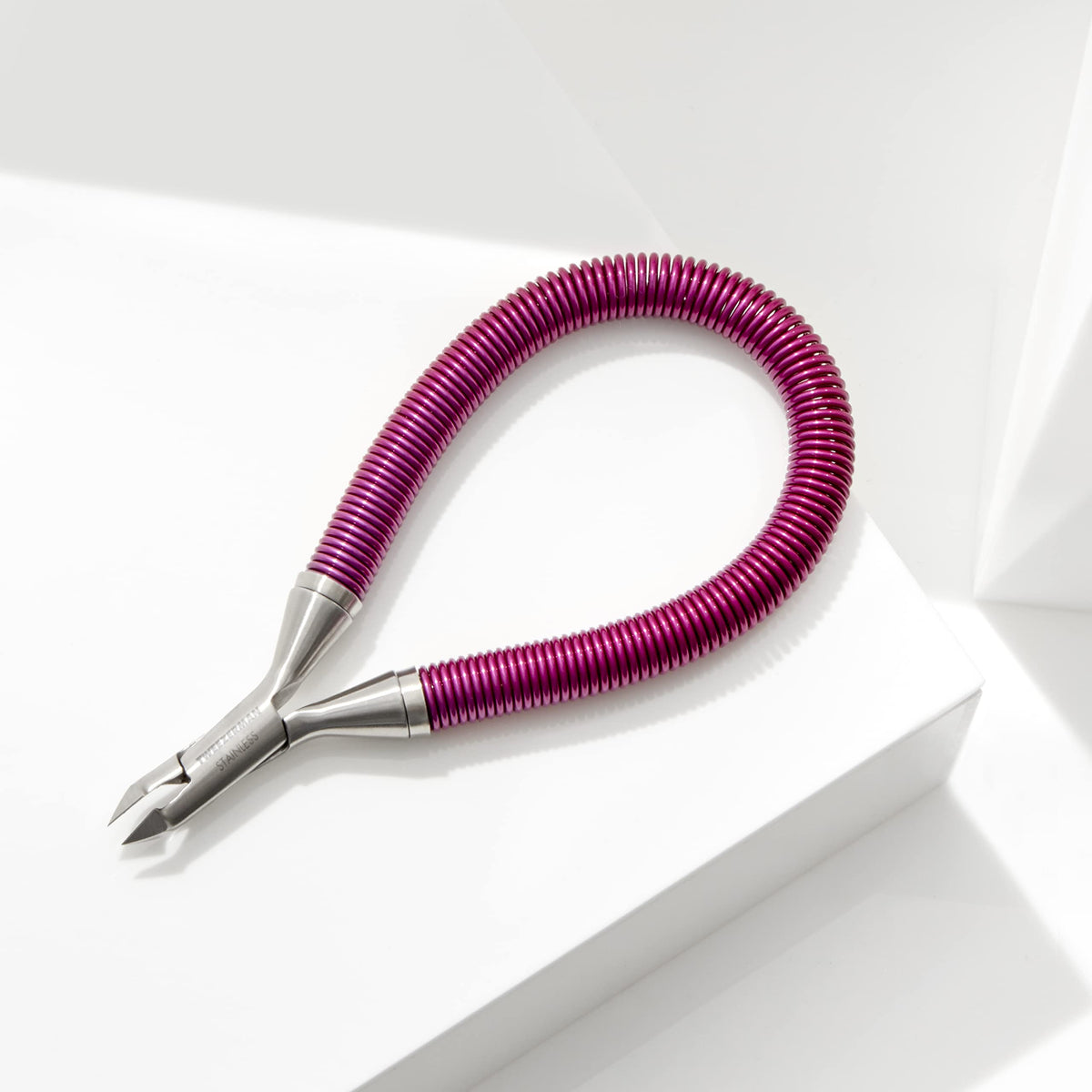 Tweezerman in use trimming cuticle demonstrating accurate removal and neat nails benefit