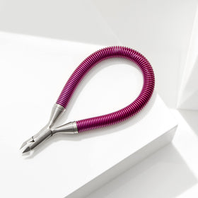 Tweezerman in use trimming cuticle demonstrating accurate removal and neat nails benefit