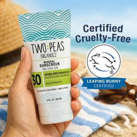Two Peas Organics applying sunscreen on baby arm for gentle protection