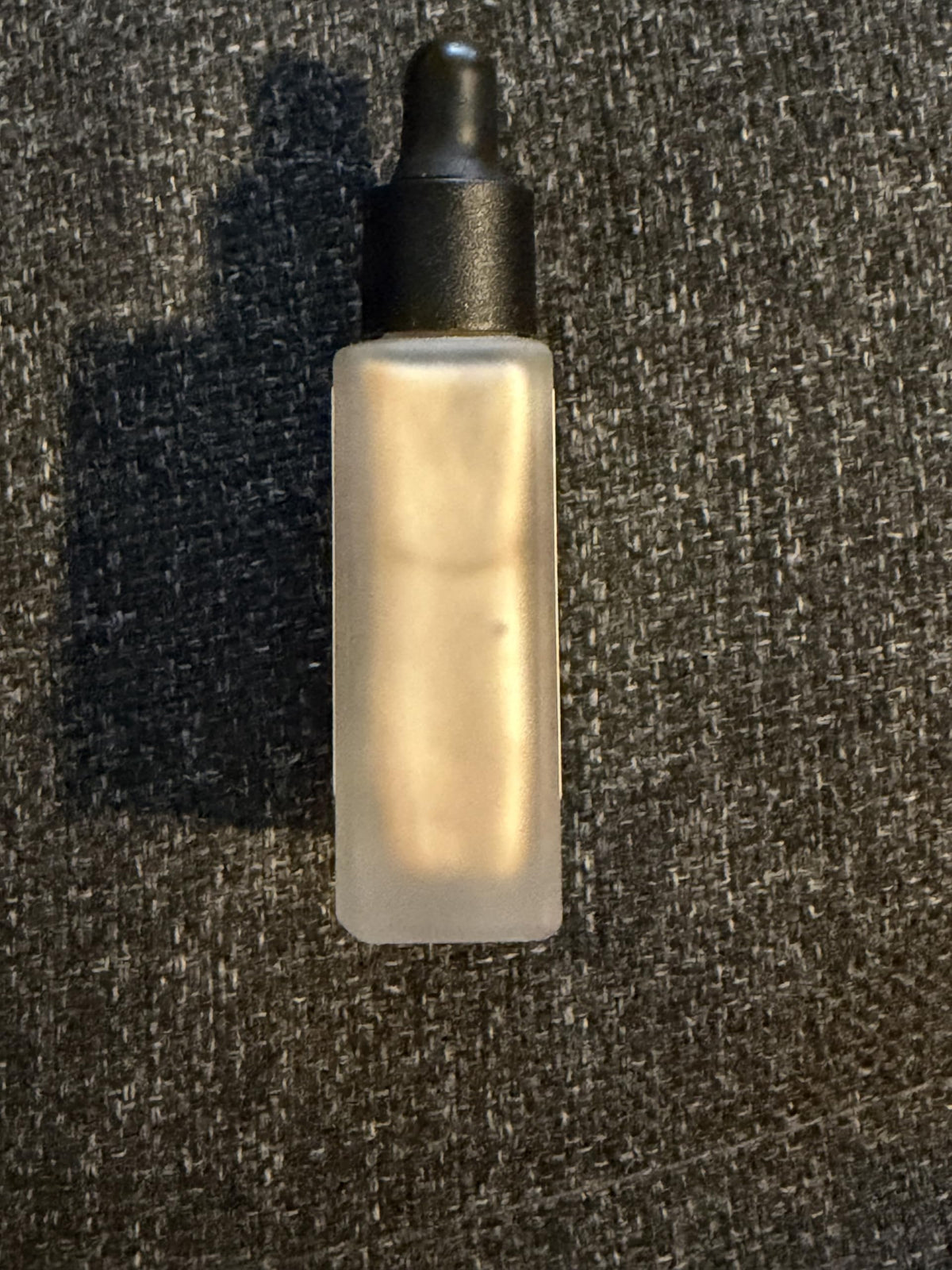 Typology drop mixed into moisturizer showing blendability benefit: instant dewy boost