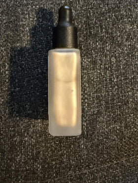 Typology drop mixed into moisturizer showing blendability benefit: instant dewy boost