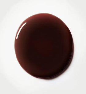 Typology lip oil applied on lips demonstrating sheer black cherry tint benefit
