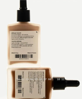 Typology tinted serum applied on hand to show coverage and blendability