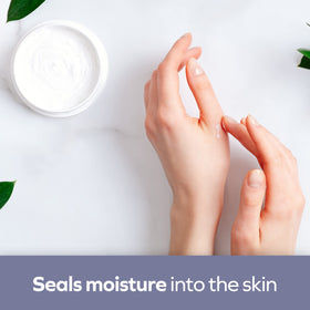 Applying Udderly Smooth on hands to hydrate dry skin and restore softness