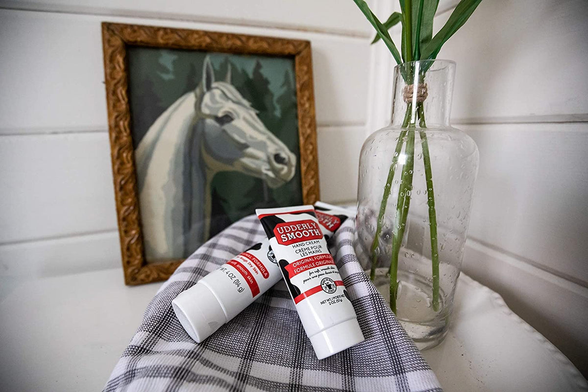udderly smooth next to common items showing 4 oz size and portability