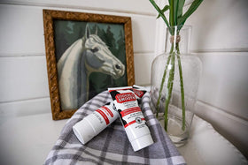 udderly smooth next to common items showing 4 oz size and portability