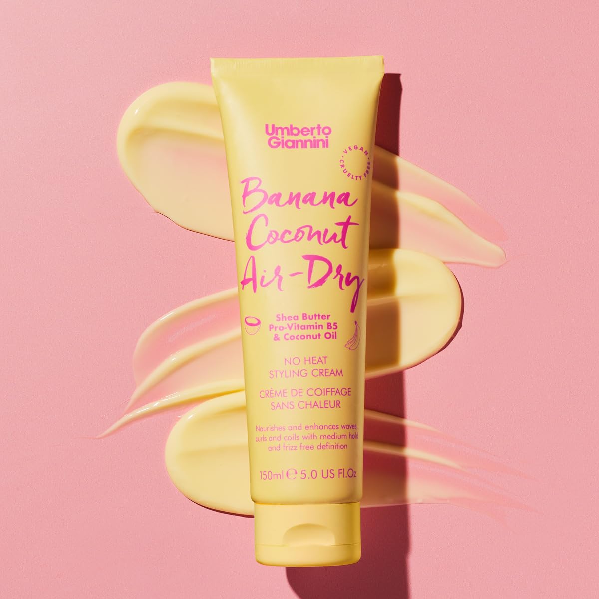 Umberto Giannini cream in hand being applied to damp hair for hydration