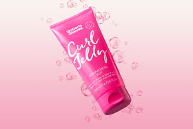 Umberto Giannini close-up on a shiny defined curl showing glossy finish and frizz reduction