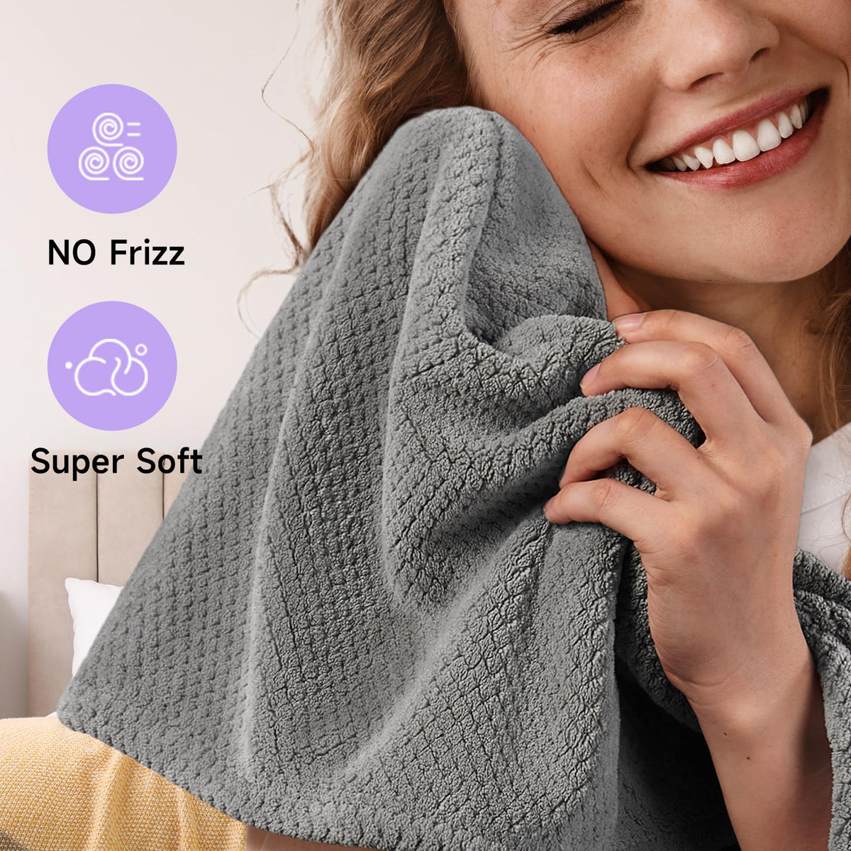 Umisleep towel next to hand to show 26 by 10 inch size for thick hair coverage