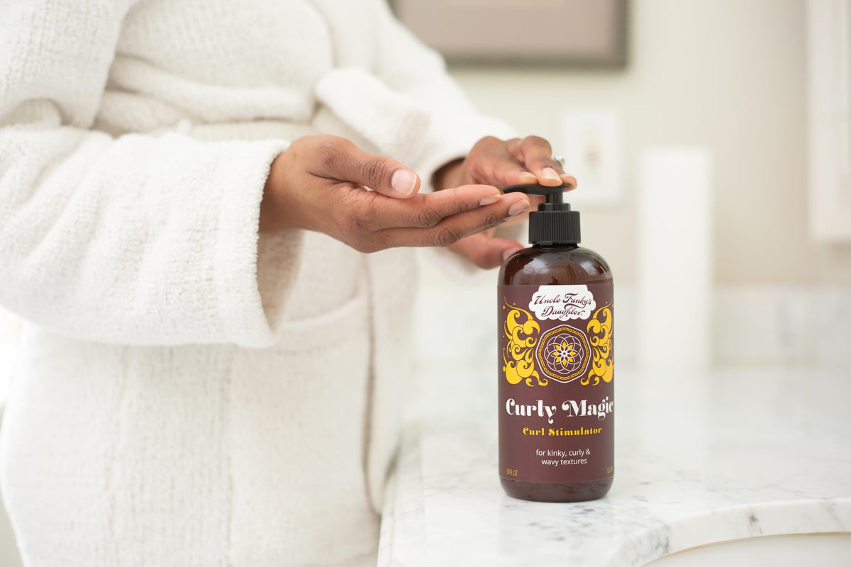 Uncle Funky's Daughter being applied to curly hair for easier detangling benefit