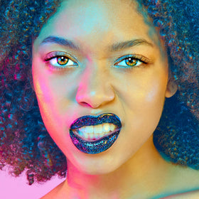 UNICORN SNOT model wearing Chasm duo at night showcasing dramatic long-lasting shine