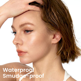 Unicos stamp in use pressing wing near eye with mirror for accurate placement