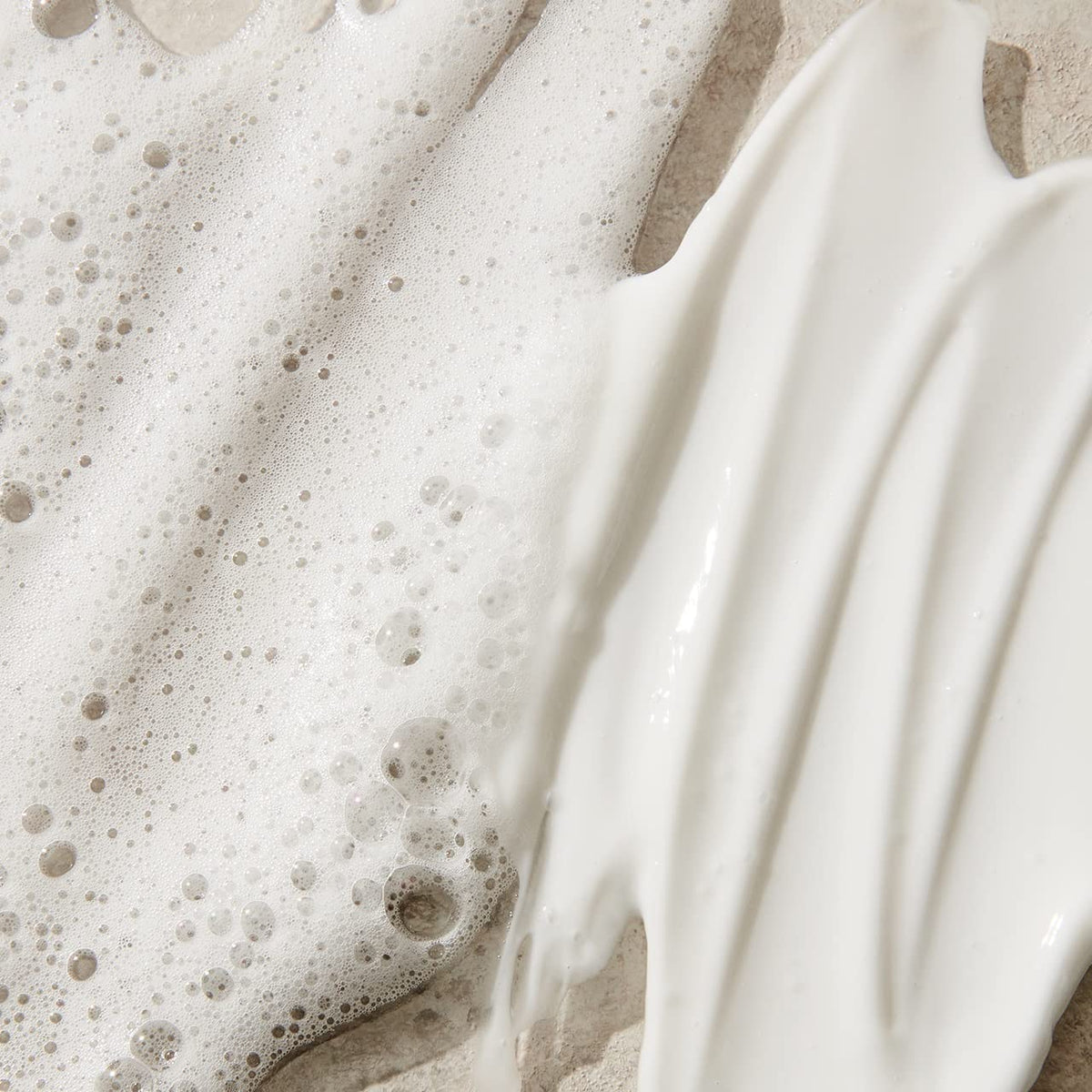 UNITE conditioner being rinsed in salon showing detangling benefit