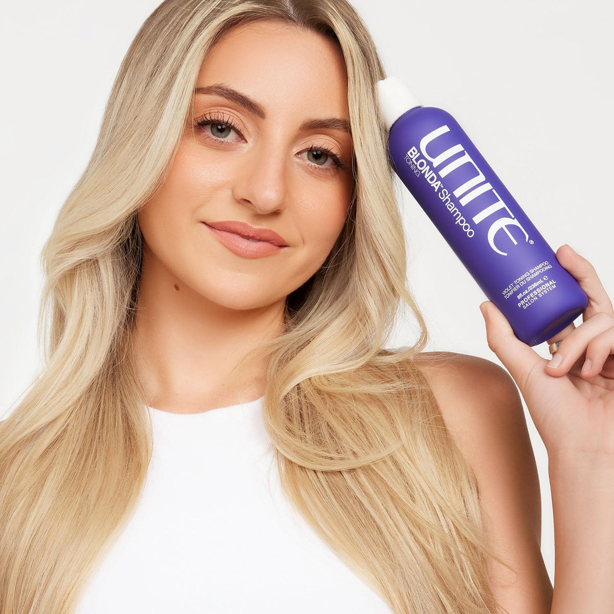 UNITE Hair BLONDA beside ruler showing 33.8 fl oz scale, long-lasting professional volume