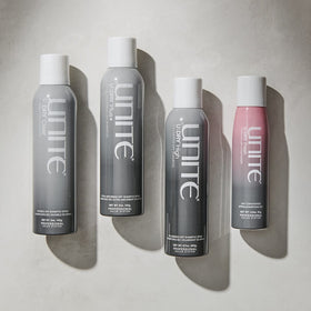 UNITE U:DRY Fresh next to hairbrush showing compact travel-friendly size